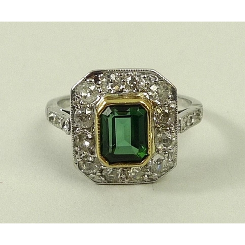 810 - An Art Deco white gold, diamond and green tourmaline ring, the emerald cut tourmaline surrounded by ... 