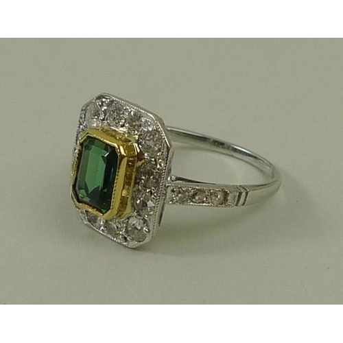 810 - An Art Deco white gold, diamond and green tourmaline ring, the emerald cut tourmaline surrounded by ... 