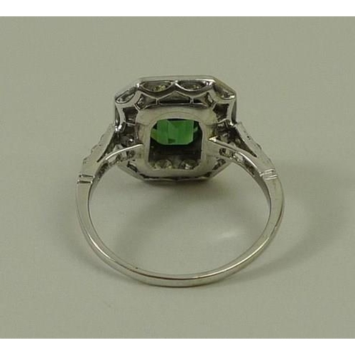 810 - An Art Deco white gold, diamond and green tourmaline ring, the emerald cut tourmaline surrounded by ... 