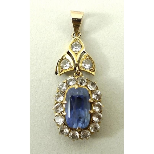 812 - A 9ct gold and sapphire oval pendant in a surround of white sapphires on a white sapphire set suspen... 