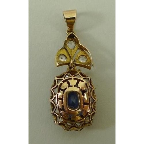 812 - A 9ct gold and sapphire oval pendant in a surround of white sapphires on a white sapphire set suspen... 