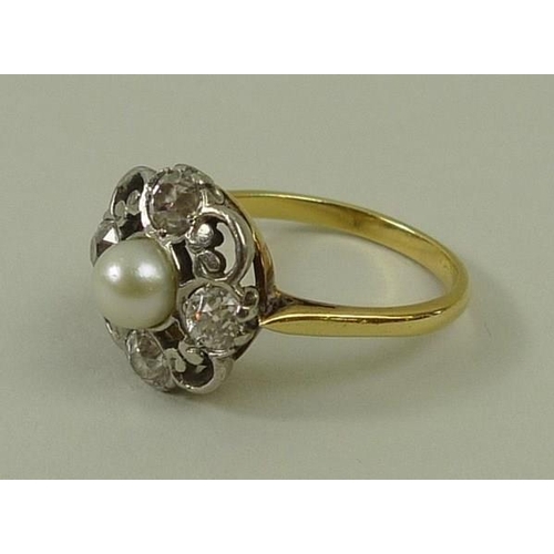 814 - An 18ct gold and platinum set diamond and pearl ring, the central pearl, 4mm, with a 0.2ct diamond s... 