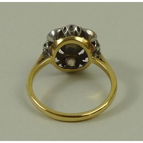 814 - An 18ct gold and platinum set diamond and pearl ring, the central pearl, 4mm, with a 0.2ct diamond s... 