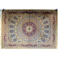 A Keshan rug with fawn ground, central multi petalled medallion and radiating patterned field in red... 