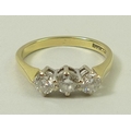 An 18ct gold and diamond three stone ring, the central diamond of approximately 0.25ct, with 0.125ct... 