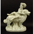 A Staffordshire pearlware figure, mid 19th century, modelled as a boy sitting on a large dog, on an ... 