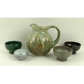 A group of vintage studio pottery items comprising a fluted jug, 17cm, three bowls, 9.5 by 6cm, and ... 