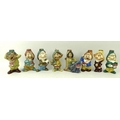 A group of eight ceramic liquor bottles, hand painted and modelled as Snow White and the Seven Dwarv... 