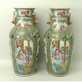 A pair of Canton porcelain vases, early 19th century, the flared and frill moulded rims above lion d... 