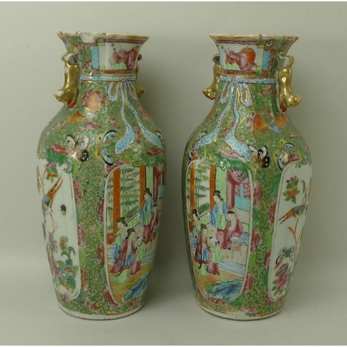 533 - A pair of Canton porcelain vases, early 19th century, the flared and frill moulded rims above lion d... 