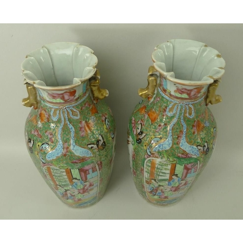 533 - A pair of Canton porcelain vases, early 19th century, the flared and frill moulded rims above lion d... 