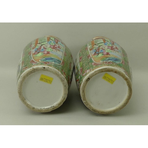 533 - A pair of Canton porcelain vases, early 19th century, the flared and frill moulded rims above lion d... 