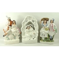 A group of three late 19th century Staffordshire figures, all modelled as couples, comprising seated... 