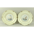 A pair of Royal Crown Derby plates, each depicting yachts at sea, titled verso 'Endymion' and 'Vagab... 