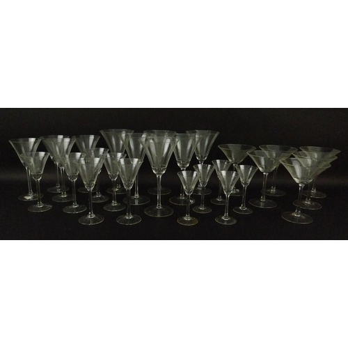 547 - A collection of Art Deco champagne and wine glasses with cone shaped bowls etched with cross hatched... 