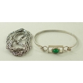 A Russian green stone cabochon set silver bangle, and a silver chain necklace. (2)