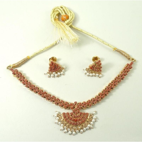 790 - An Indian coral necklace, the coral set in gold plated on silver, with a cord tie fastener, and a pa... 