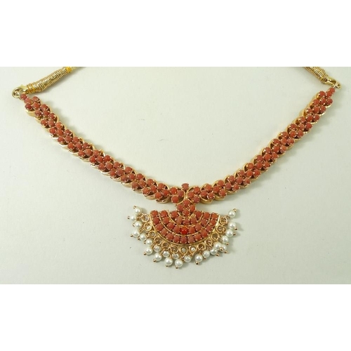 790 - An Indian coral necklace, the coral set in gold plated on silver, with a cord tie fastener, and a pa... 