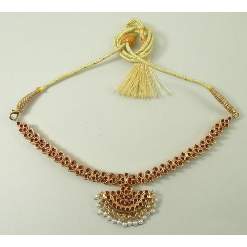 790 - An Indian coral necklace, the coral set in gold plated on silver, with a cord tie fastener, and a pa... 