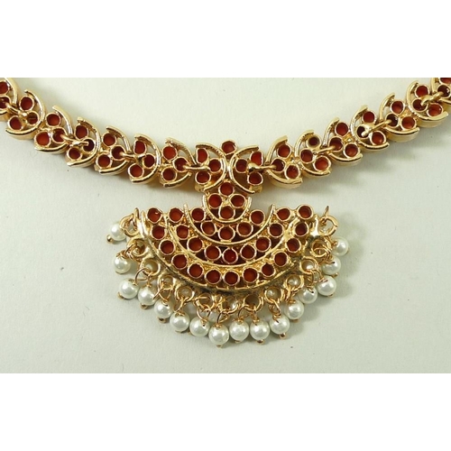 790 - An Indian coral necklace, the coral set in gold plated on silver, with a cord tie fastener, and a pa... 