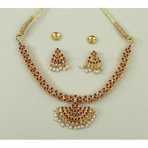 790 - An Indian coral necklace, the coral set in gold plated on silver, with a cord tie fastener, and a pa... 