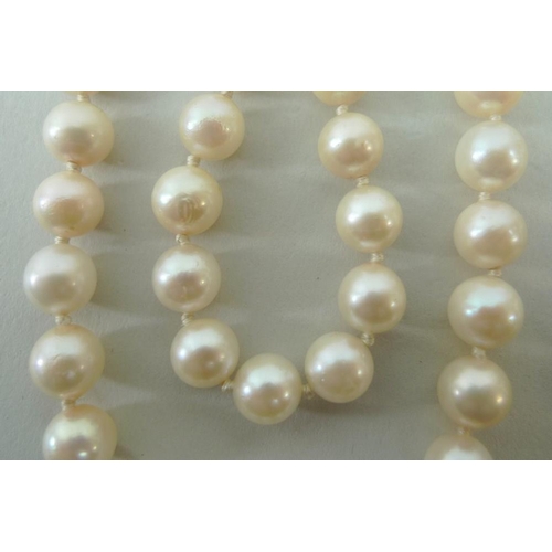 791 - A string of pearls with an 18ct gold rope twist clasp set with a single pearl, the 95 pearls separat... 