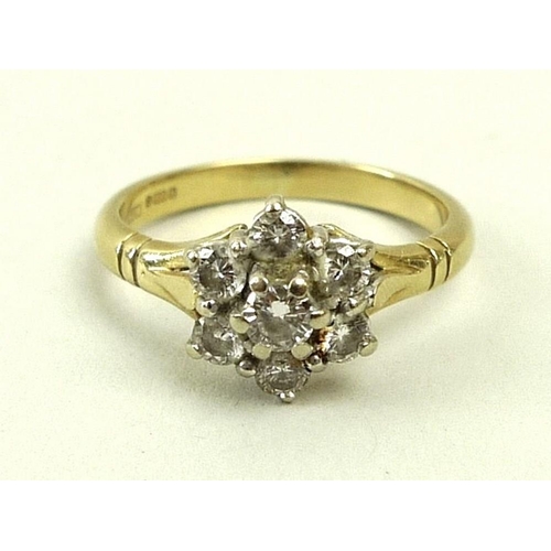 792 - An 18ct gold and diamond ring of flower cluster formation, the central diamond of approximately 0.12... 