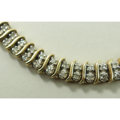 795 - A Miuko 9ct gold and diamond link bracelet, formed as fifty-three pairs of diamonds divided by elong... 