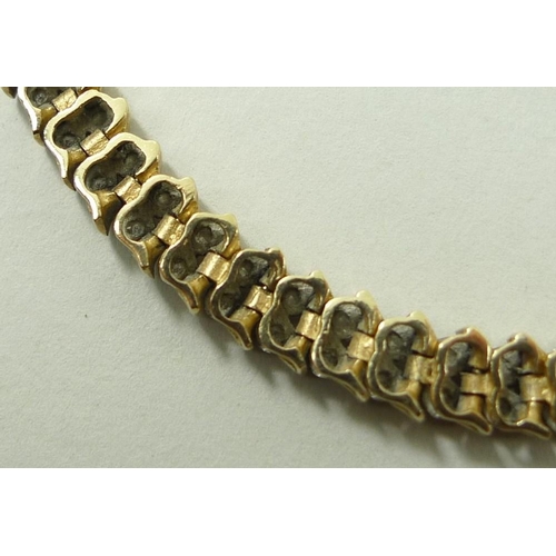 795 - A Miuko 9ct gold and diamond link bracelet, formed as fifty-three pairs of diamonds divided by elong... 