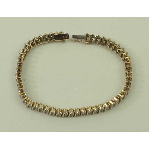 795 - A Miuko 9ct gold and diamond link bracelet, formed as fifty-three pairs of diamonds divided by elong... 