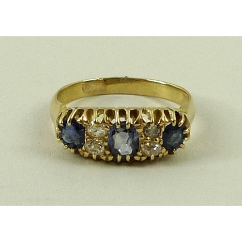 799 - An 18ct gold, sapphire and diamond ring set with three sapphires divided by two pairs of diamonds, s... 