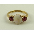 An 18ct gold, opal and ruby ring, the central oval opal flanked by two diamonds, 3g total weight, si... 