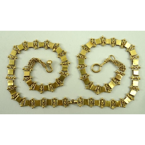 810 - An Indian gold necklace, tests as 18ct, of square links joined by curved links, 27.4g, 49cm long.