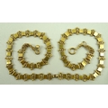 An Indian gold necklace, tests as 18ct, of square links joined by curved links, 27.4g, 49cm long.
