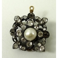 An Edwardian diamond and pearl pendant brooch, of quatrefoil form, set with a central pearl, surroun... 