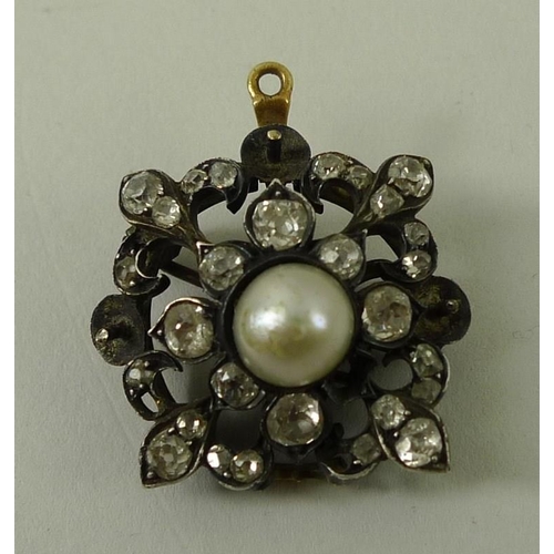 812 - An Edwardian diamond and pearl pendant brooch, of quatrefoil form, set with a central pearl, surroun... 