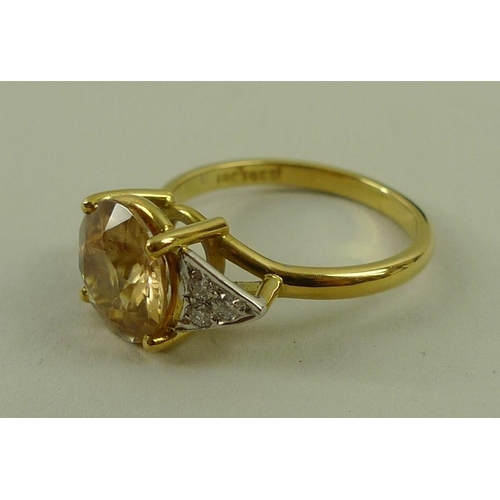 815 - An 18ct gold, diamond and apricot zircon ring, the central peach coloured zircon measuring 8mm diame... 