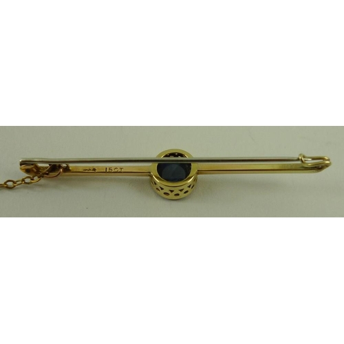 819 - A 15ct gold and black opal bar brooch, the central circular black opal in a beaded setting, 3.2g tot... 