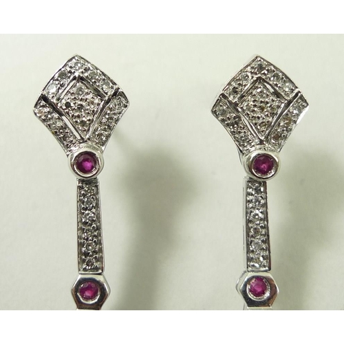 821 - A pair of drop earrings, set with diamonds and four rubies, the stud of diamond form leading to hear... 