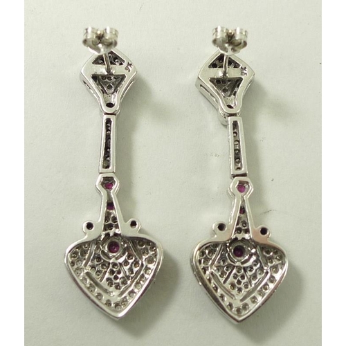 821 - A pair of drop earrings, set with diamonds and four rubies, the stud of diamond form leading to hear... 