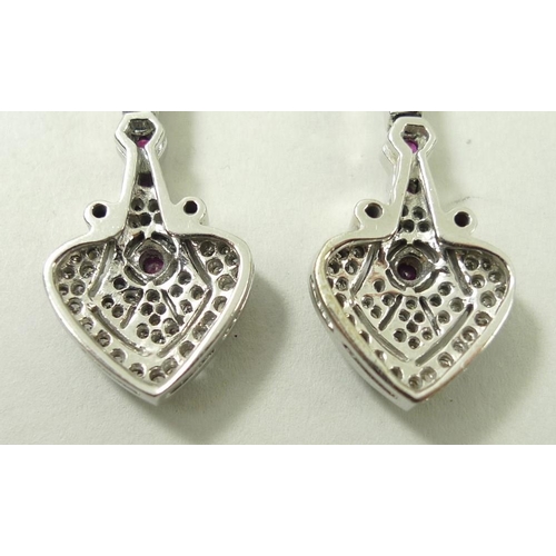 821 - A pair of drop earrings, set with diamonds and four rubies, the stud of diamond form leading to hear... 