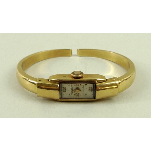 824 - A lady's Baume & Mercier 18ct gold bracelet watch, the tank cased watch with quarter Arabic numerals... 