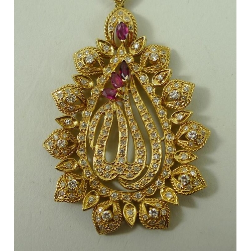 828 - A ruby and diamond necklace, the central Arabesque pendant suspended below a trefoil, marked 18ct to... 