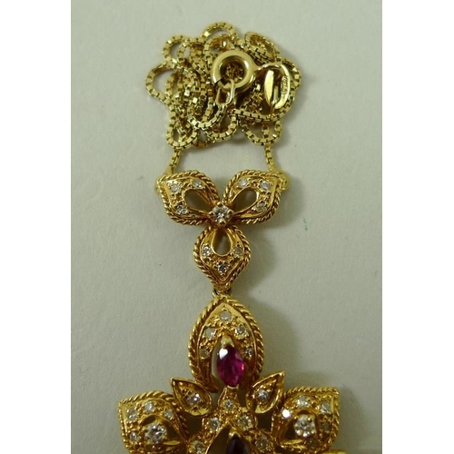 828 - A ruby and diamond necklace, the central Arabesque pendant suspended below a trefoil, marked 18ct to... 