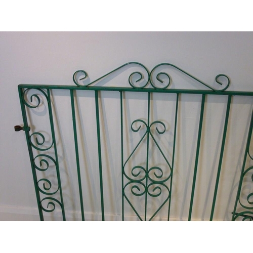 832 - A pair of mid 20th century driveway gates of steel construction with scrollwork design, latch, centr... 