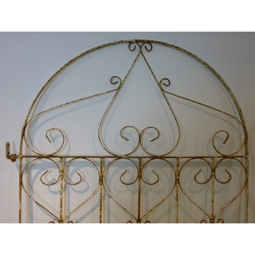 834 - A 20th century wrought iron arched gate, of scrollwork design, with latch, 103 by 192cm, together wi... 