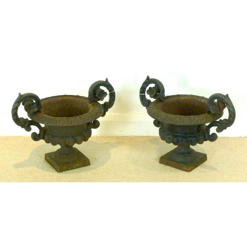 837 - A pair of campana cast iron garden urns, 51 by 35 by 39cm high.