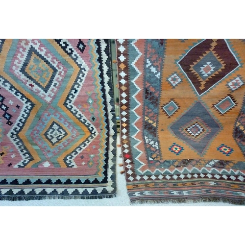 844 - Two early 20th century Kelim rugs, orange ground, 278 by 148cm, and pink ground, 268 by 134cm. (2)