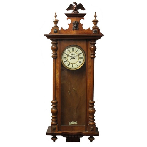 851A - A Vienna wall clock, with Roman numerals, with pendulum, two weights, and winder, 45 by 17 by 123cm.