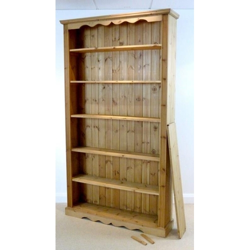 852 - A modern pine bookcase, with one fixed and five adjustable shelves, 121 by 26 by 214cm high.